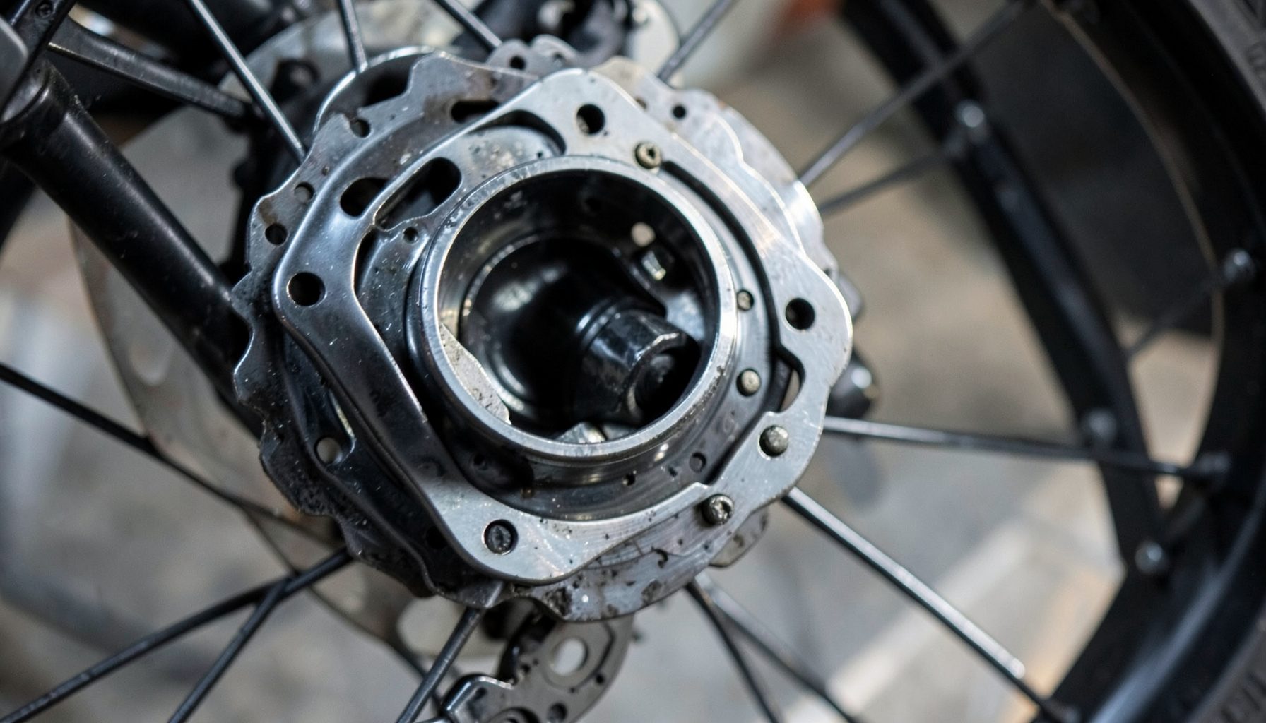 A bicycle disc brake rotor and wheel rim in sharp focus, industrial and precise